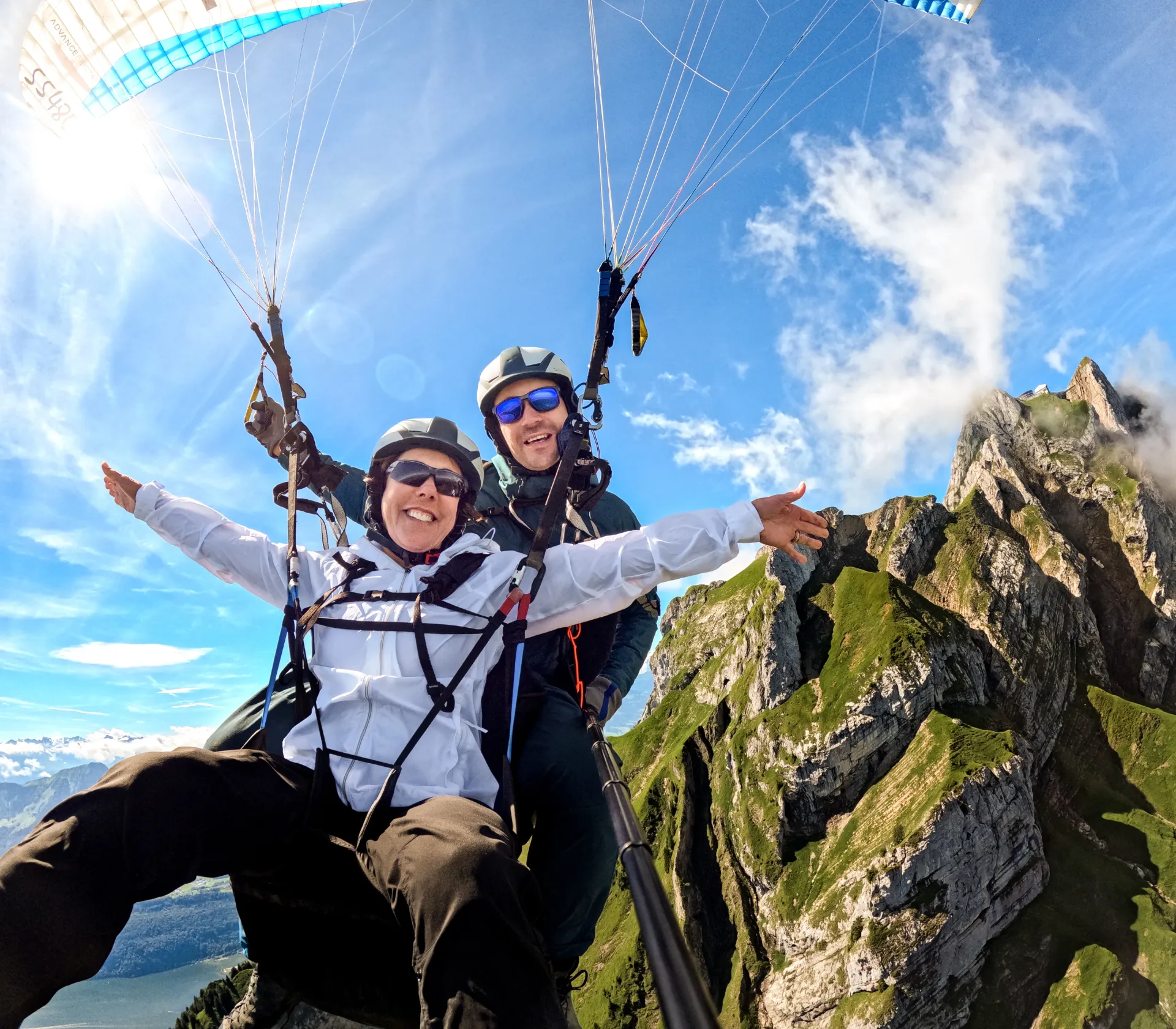 Pilot and passenger preparing for tandem paragliding on Mount Pilatus