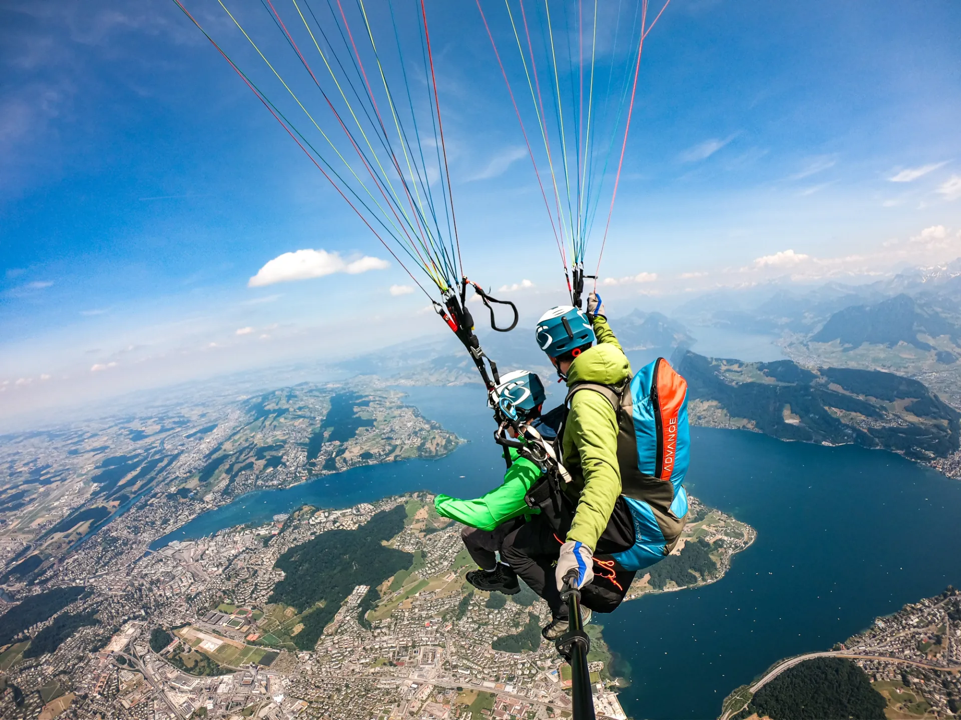 Tandem paragliding flight with wide alpine horizon near Lucerne, Switzerland